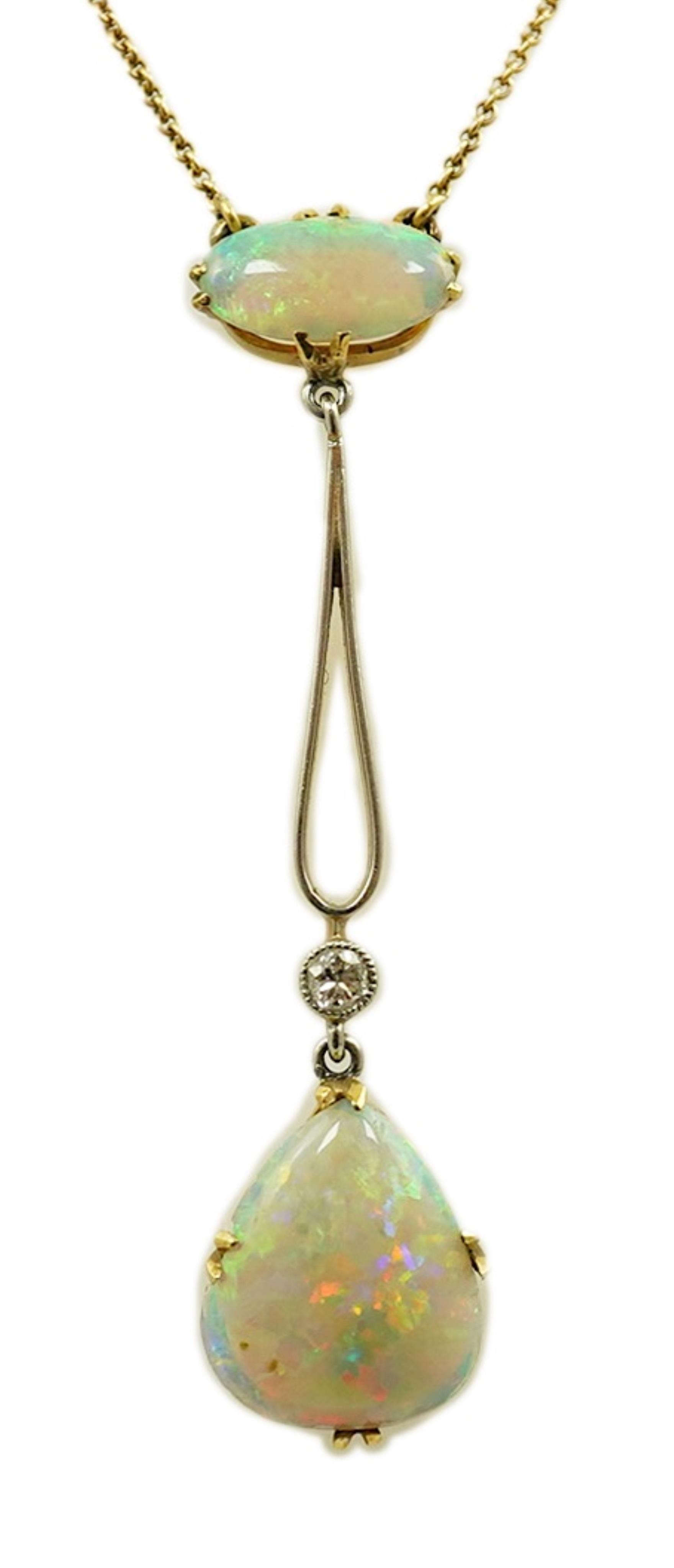 An early 20th century gold, two stone white opal and single stone diamond set drop pendant necklace